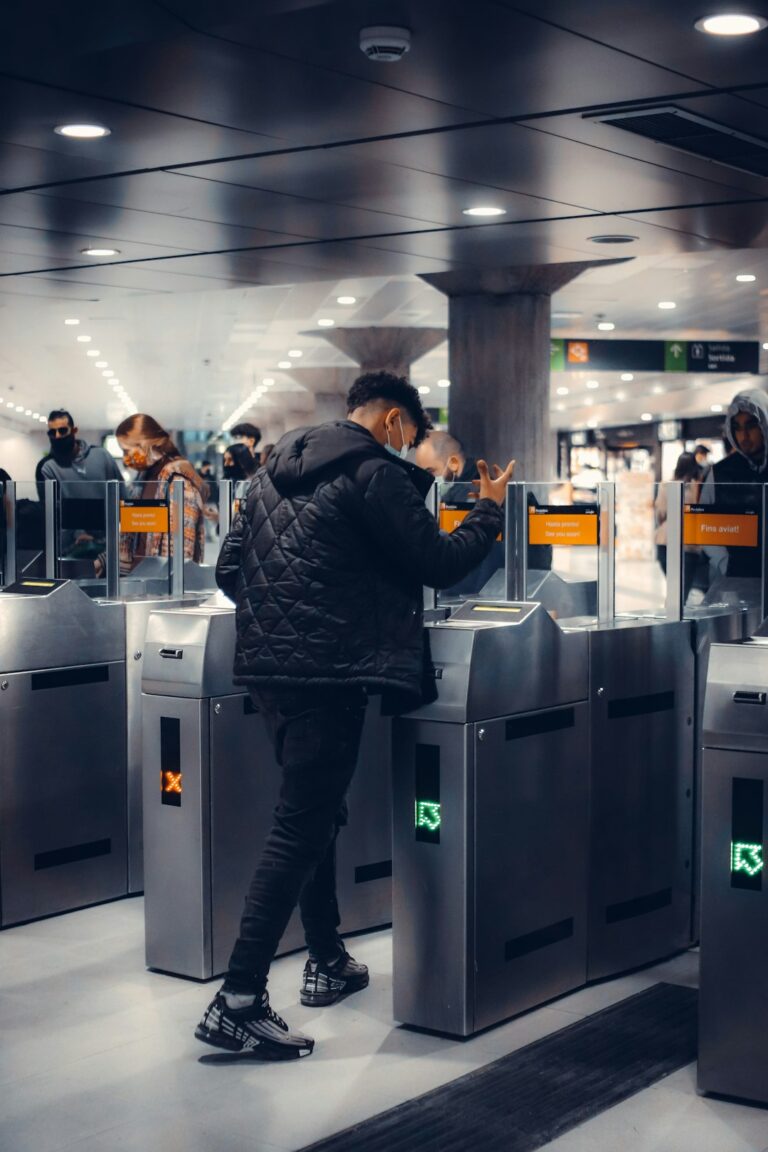 Traveler places a clear liquids bag and laptop in bins at an airport security checkpoint.